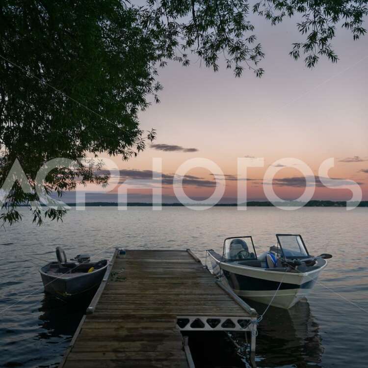 Fishing boats tied on a wooden dock - GettaPix
