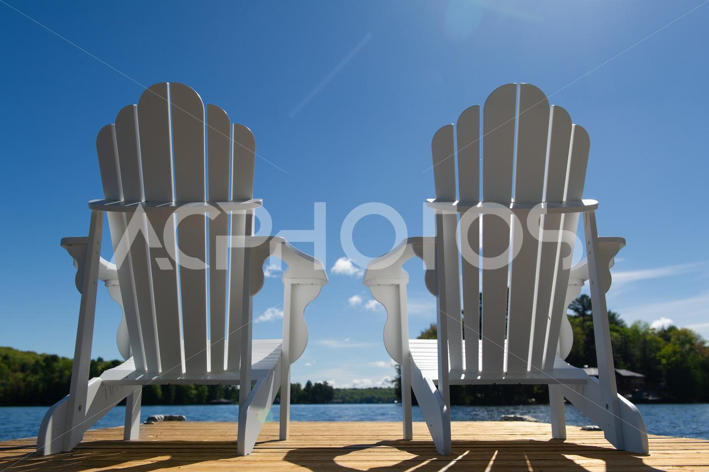 Low angle capture of two white Adirondack chair - GettaPix