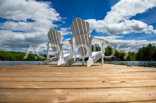 Side view of two white Adirondack chairs - GettaPix
