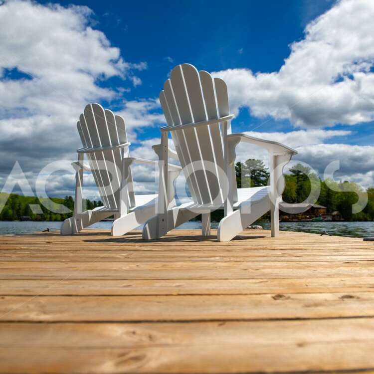 Side view of two white Adirondack chairs - GettaPix