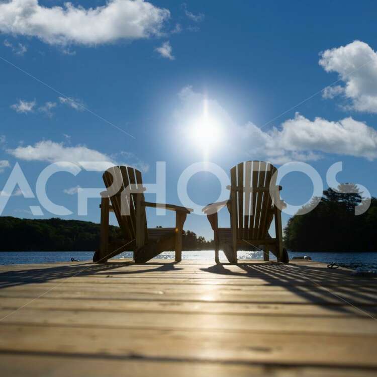 Sunrise on two empty Adirondack chairs - GettaPix