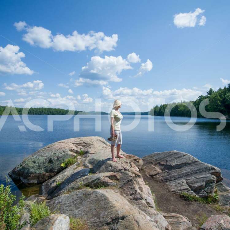 Young woman admiring Smoke lake in Algonquin Provincial Park - GettaPix
