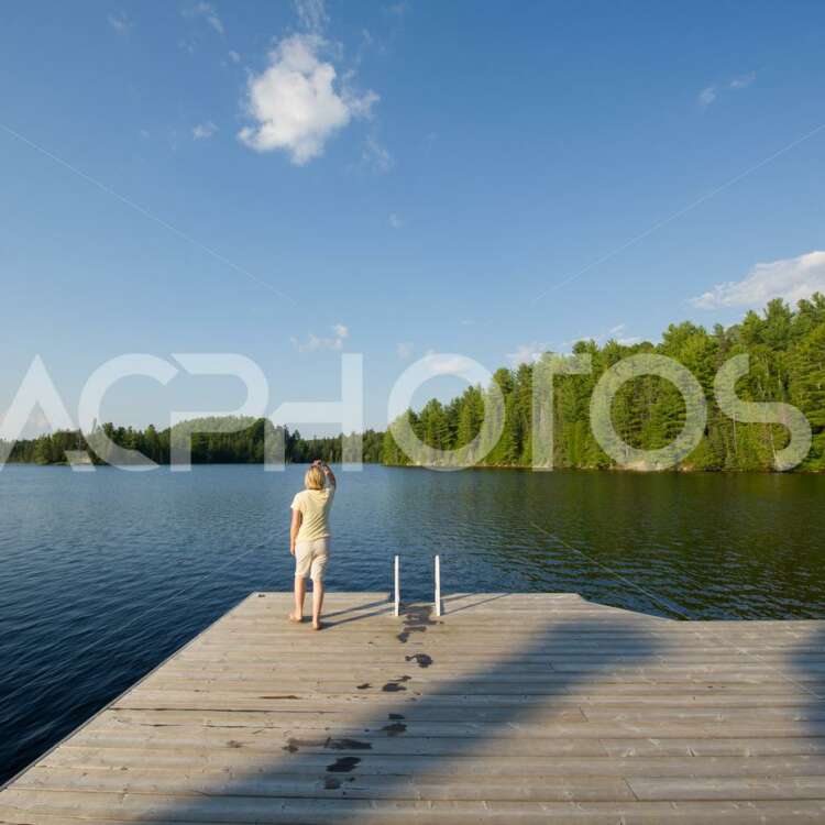 Young woman admiring the beauty of Algonquin Provincial Park in Muskoka - GettaPix